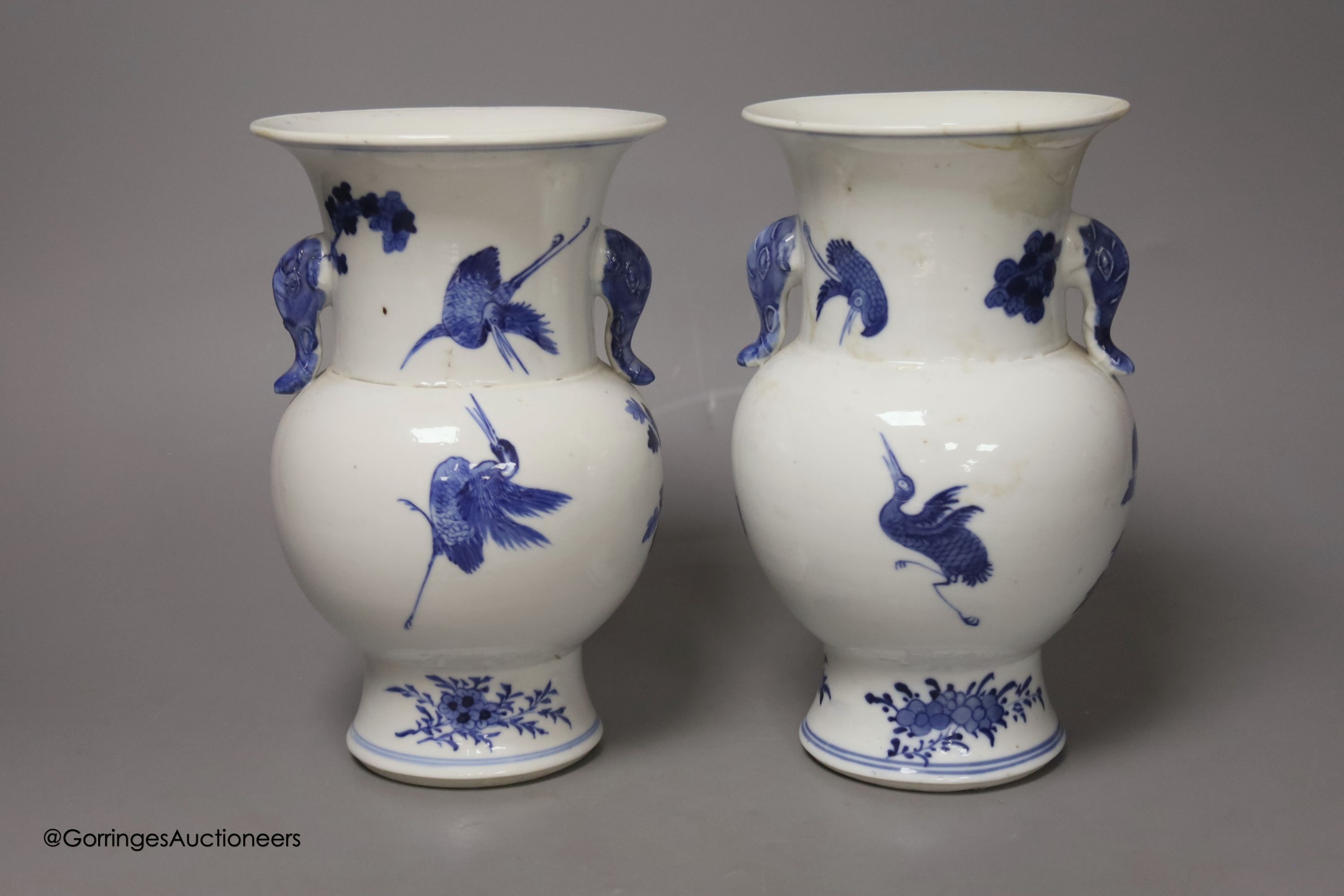 A pair of Chinese blue and white 'phoenix' vases, Kangxi marks but late 19th century, height 20cm (a.f.)